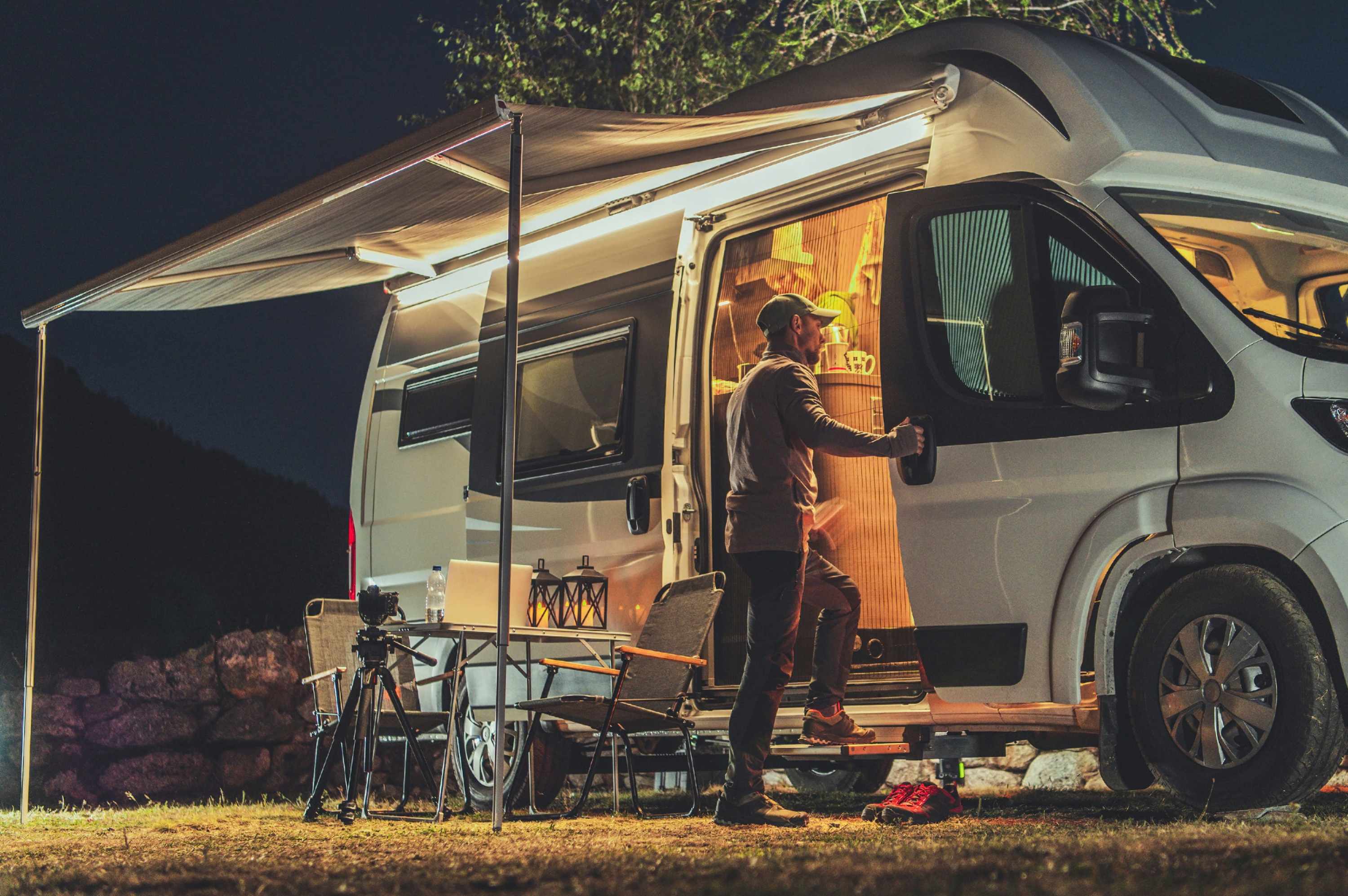 motorhome camper van parked with lights and camping equipment